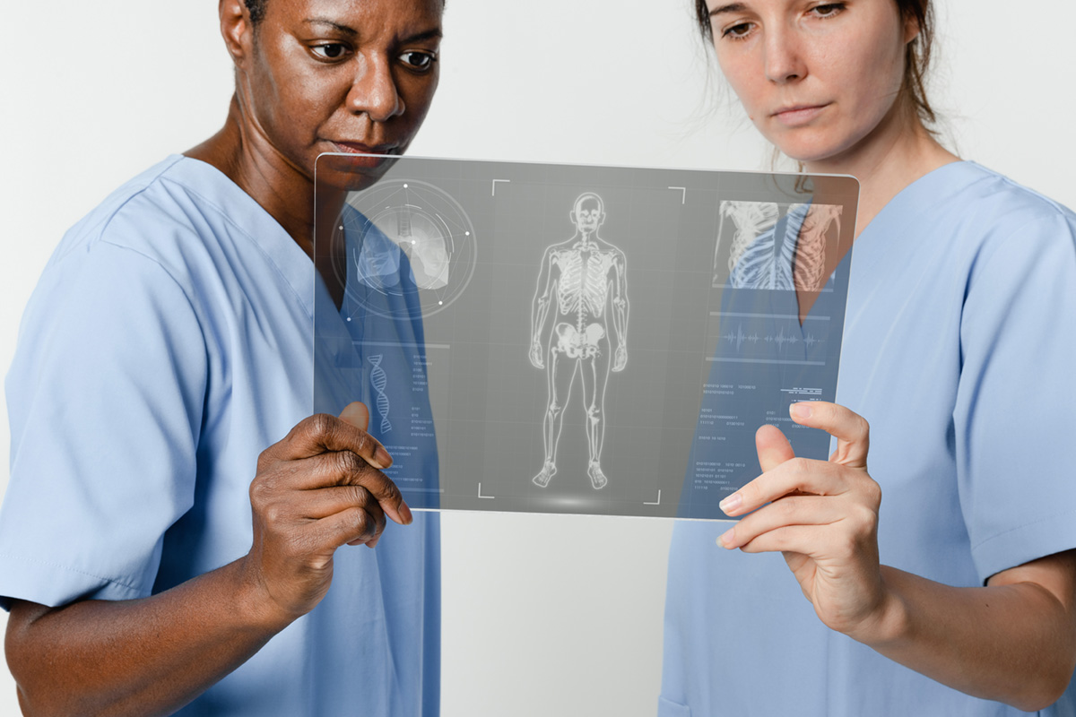 Two doctors holding and reviewing a x-ray chart.