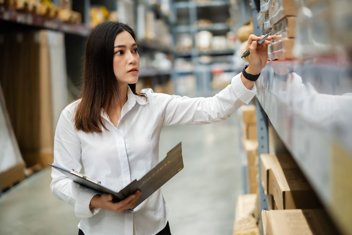 Female worker checking items at warehouse